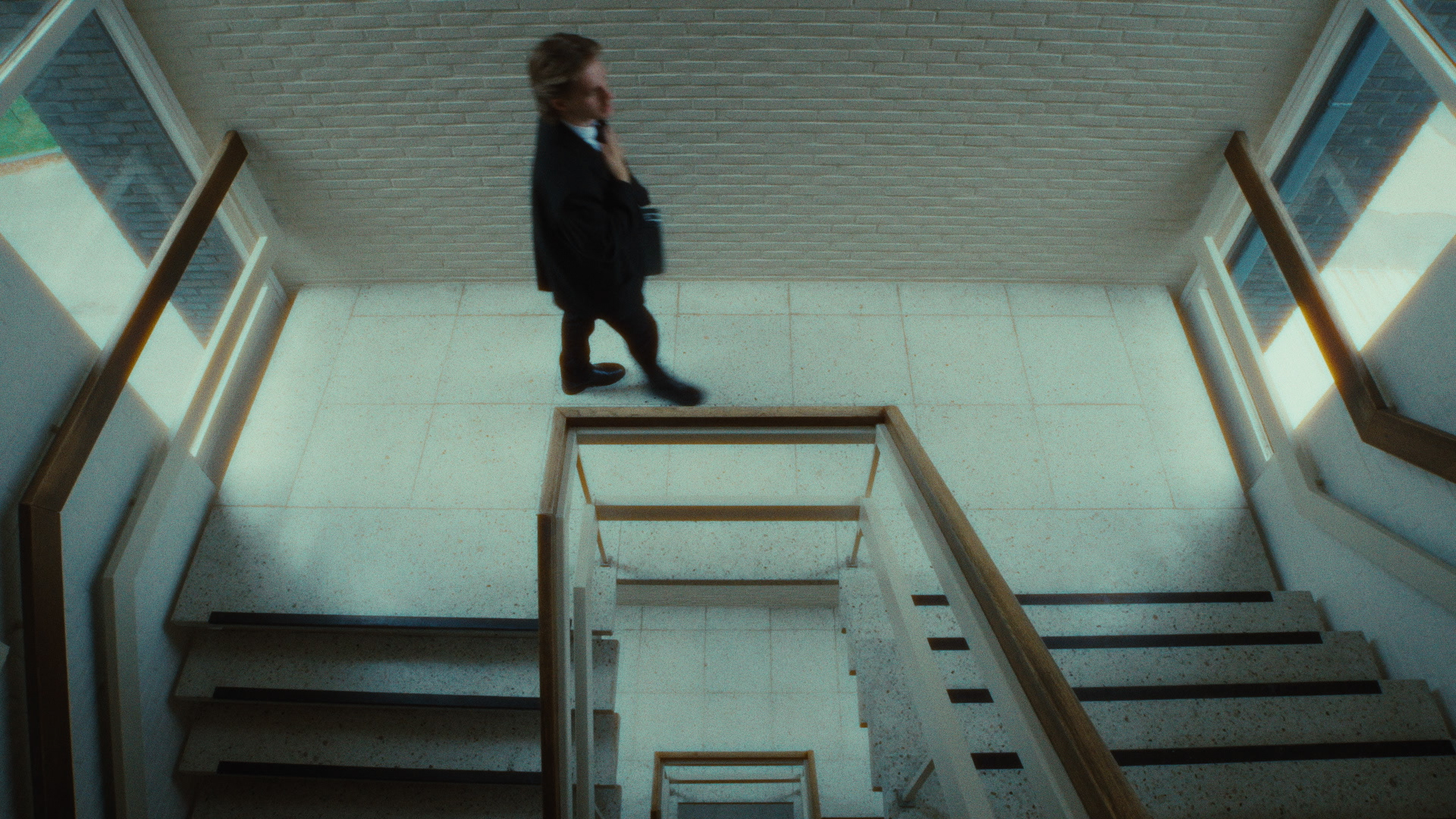 Figure descending an empty stairwell, from Dark Desire