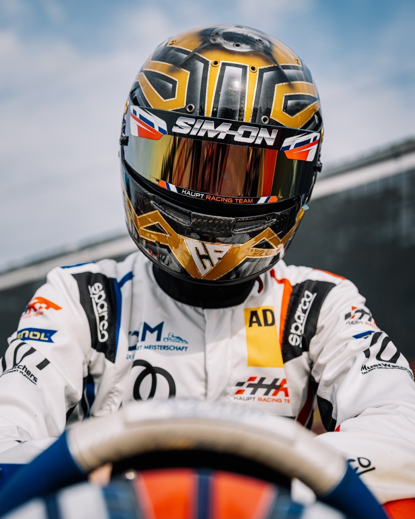 Driver at the wheel in the pit lane