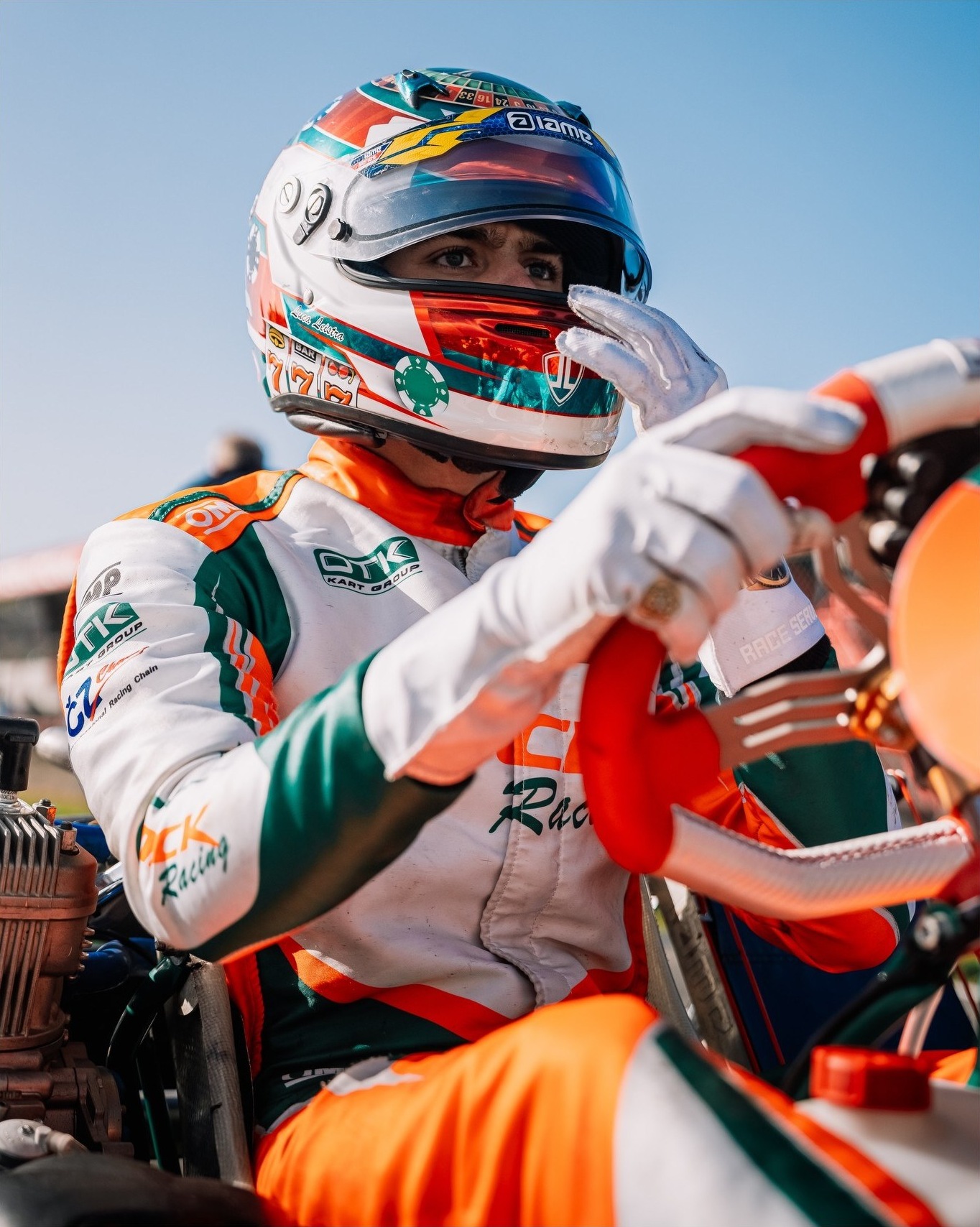 Driver pulling on gloves before the start